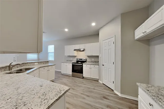 a kitchen with a sink stove and refrigerator