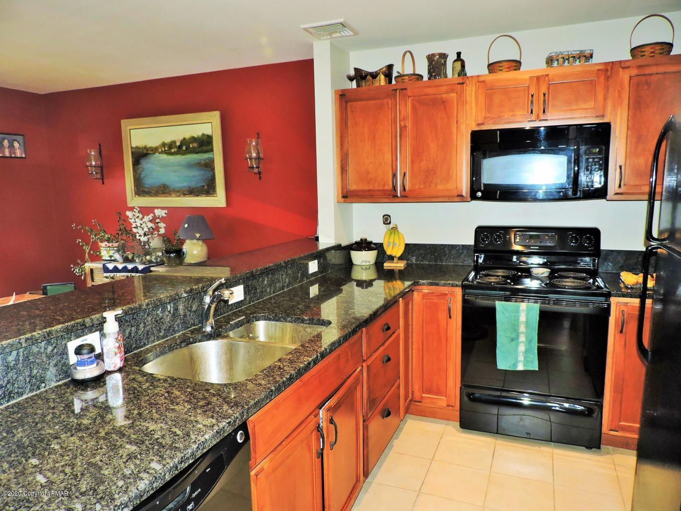 557 Upper Deer Valley Road Tannersville, PA 18372 - Photo 16 of 41 a kitchen with granite countertop a sink and a stove top oven