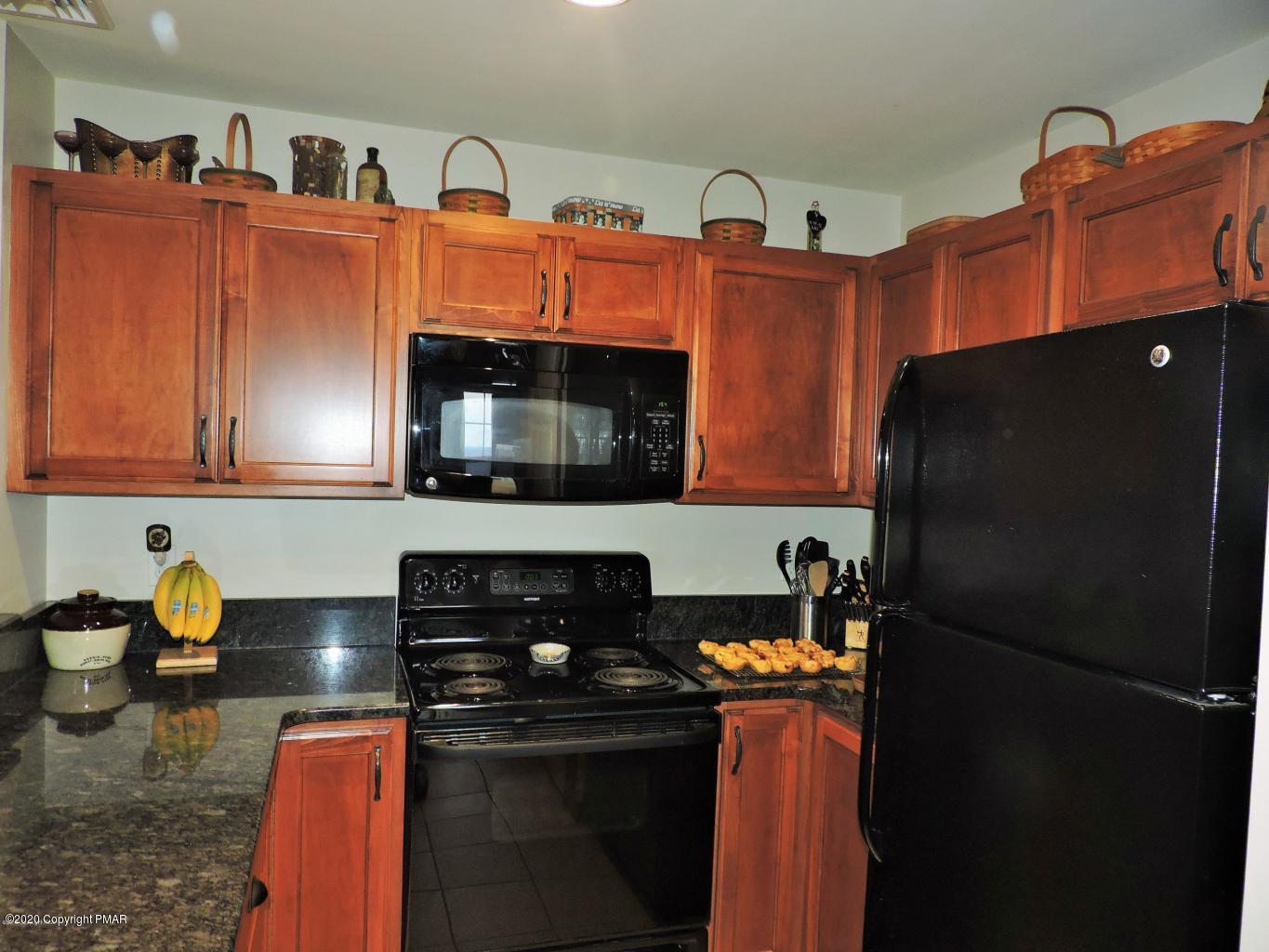 557 Upper Deer Valley Road Tannersville, PA 18372 - Photo 17 of 41 a kitchen with stainless steel appliances granite countertop a refrigerator and a stove top oven
