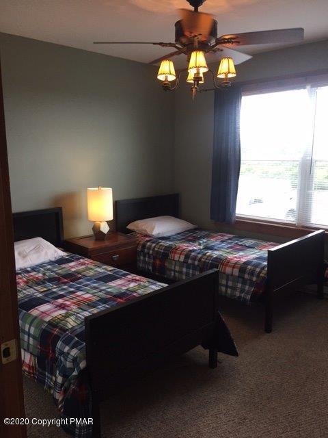 557 Upper Deer Valley Road Tannersville, PA 18372 - Photo 19 of 41 a bedroom with a bed dresser and a window