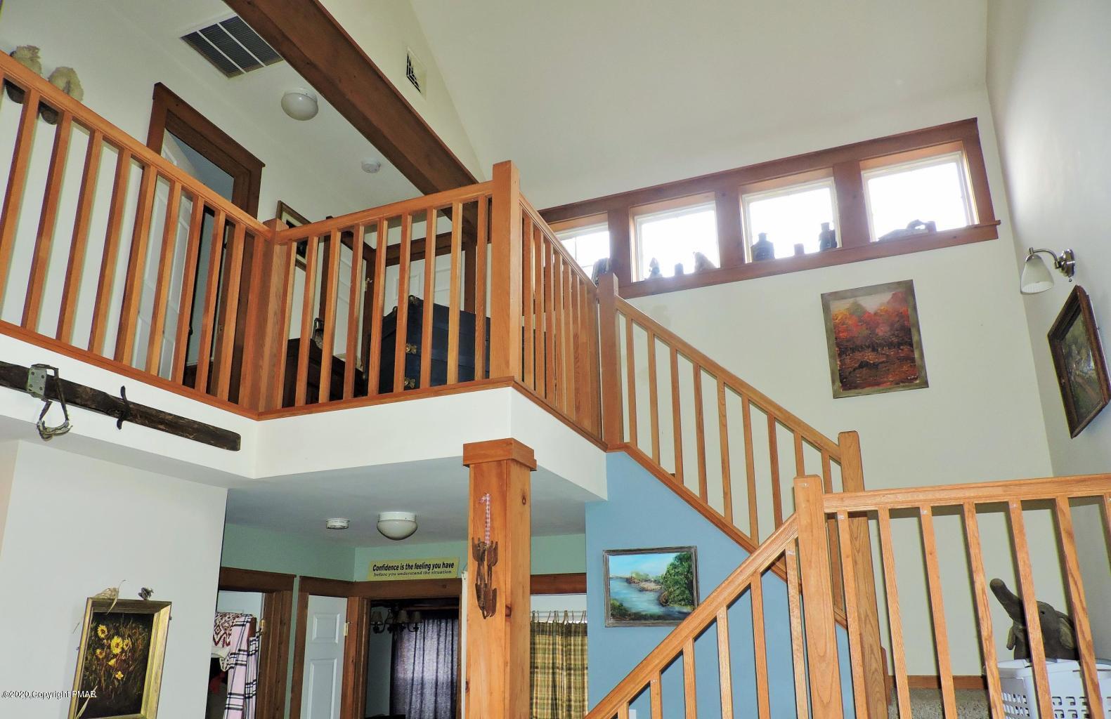 557 Upper Deer Valley Road Tannersville, PA 18372 - Photo 22 of 41 a view of staircase with lots of frames on wall and a window