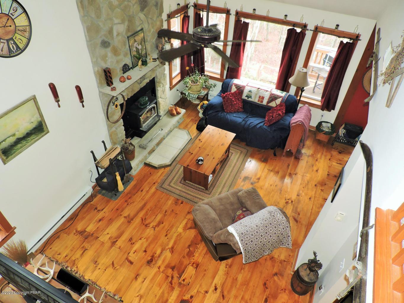 557 Upper Deer Valley Road Tannersville, PA 18372 - Photo 24 of 41 a living room with furniture and a floor to ceiling window