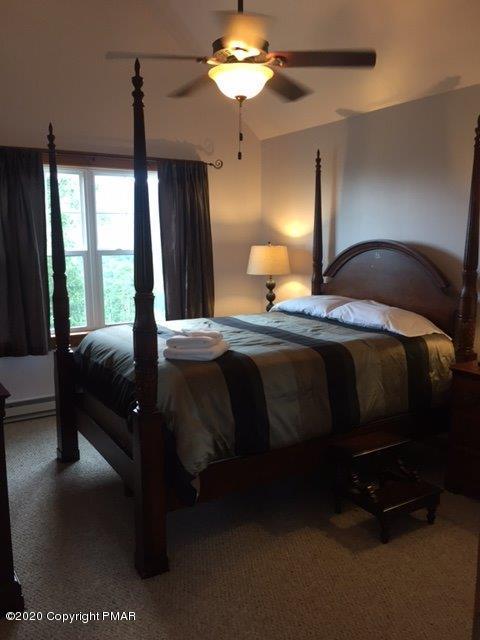557 Upper Deer Valley Road Tannersville, PA 18372 - Photo 25 of 41 a bedroom with a bed and a chandelier