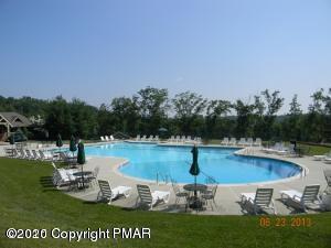 557 Upper Deer Valley Road Tannersville, PA 18372 - Photo 38 of 41 a view of a swimming pool with a table and chairs