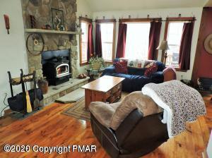 557 Upper Deer Valley Road Tannersville, PA 18372 - Photo 6 of 41 a living room with furniture and a fireplace