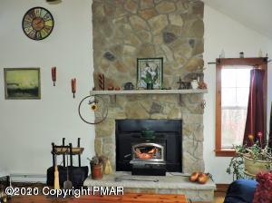 557 Upper Deer Valley Road Tannersville, PA 18372 - Photo 8 of 41 a living room with furniture and a fireplace