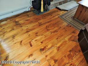 557 Upper Deer Valley Road Tannersville, PA 18372 - Photo 9 of 41 a bed sitting in a bedroom next to a large window