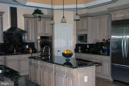 6608 Edsall Road Springfield, VA 22151 - Photo 13 of 29 a kitchen with stainless steel appliances granite countertop a sink stove and refrigerator