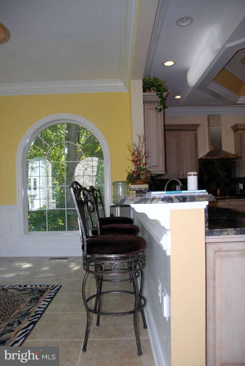 6608 Edsall Road Springfield, VA 22151 - Photo 15 of 29 a kitchen with a table chairs and a refrigerator