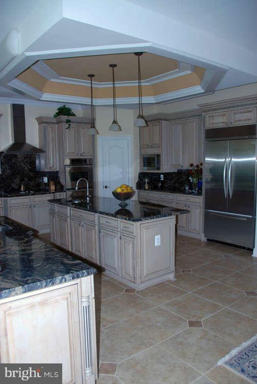6608 Edsall Road Springfield, VA 22151 - Photo 19 of 29 a kitchen with stainless steel appliances granite countertop a stove a sink and a refrigerator