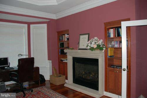 6608 Edsall Road Springfield, VA 22151 - Photo 25 of 29 a living room with furniture a fireplace and a flat screen tv