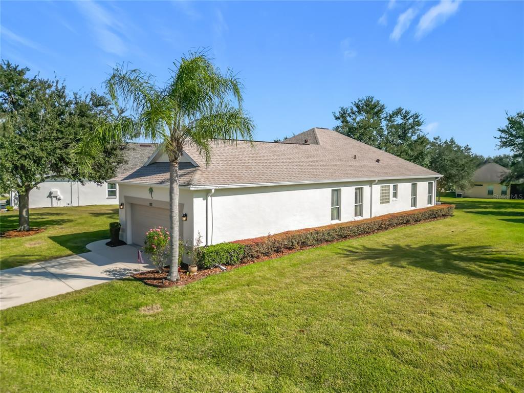 3529 Mt Hope Loop Leesburg, FL 34748 - Photo 40 of 86 a house with green field in front of it