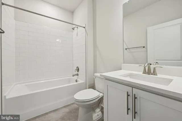 a bathroom with a sink toilet vanity and shower