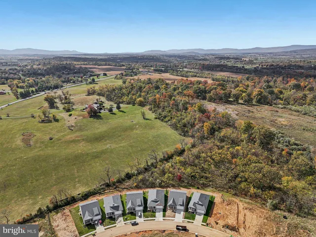an aerial view of multiple houses with yard