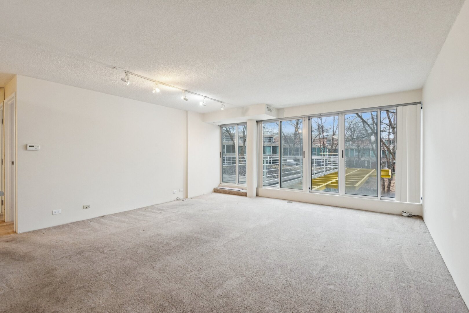 2555 Gross Point Road, Unit 101 Evanston, IL 60201 - Photo 3 of 23 a view of an empty room with a sliding door