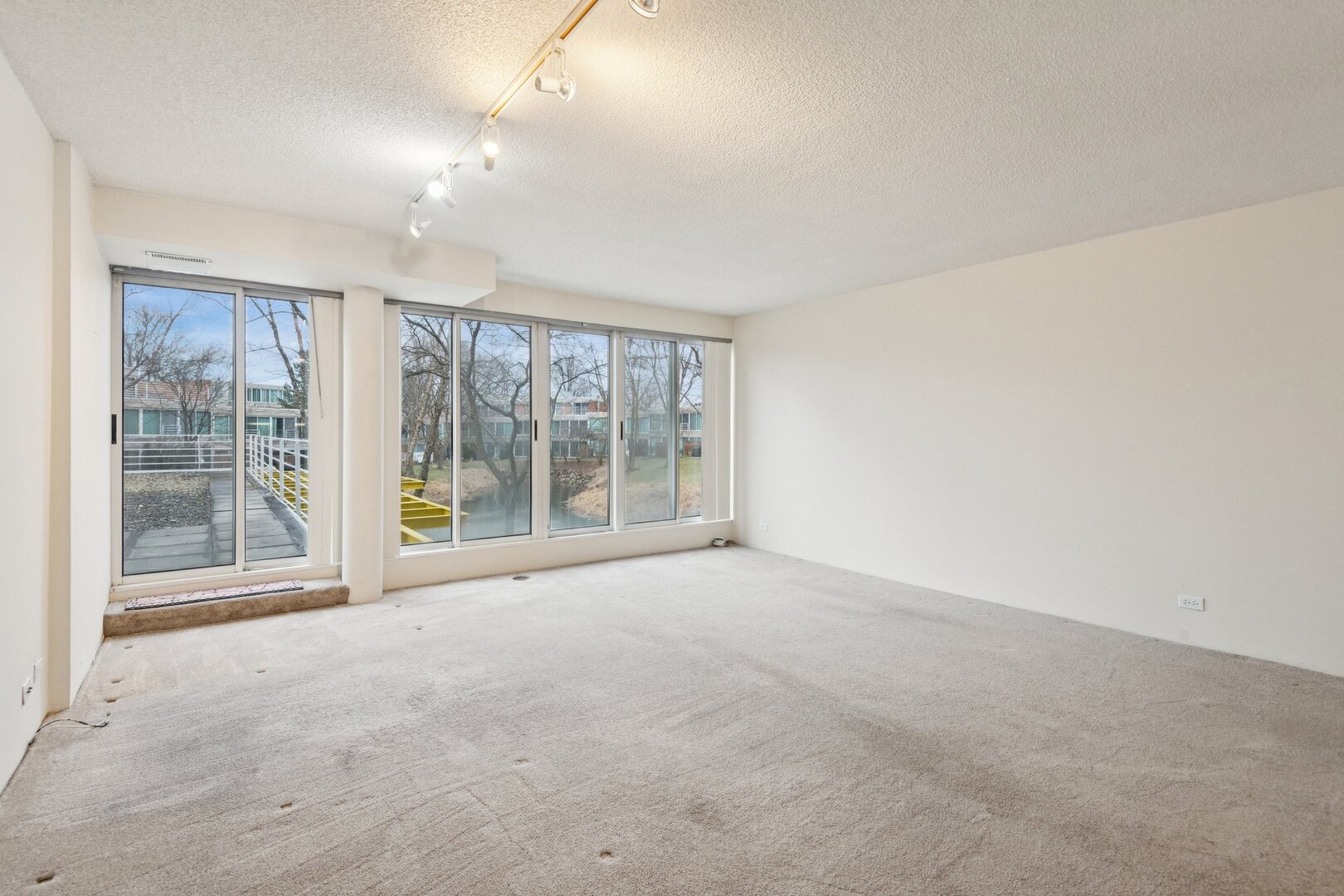 2555 Gross Point Road, Unit 101 Evanston, IL 60201 - Photo 4 of 23 a view of an empty room with a window