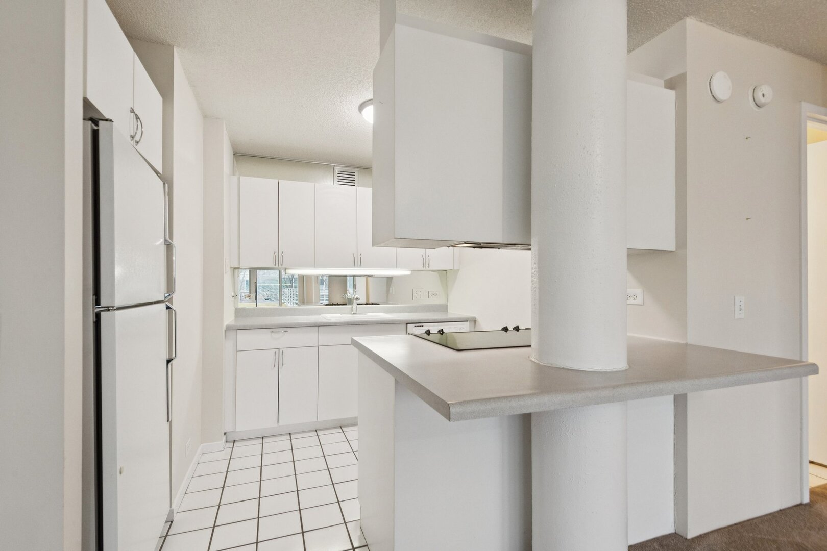 2555 Gross Point Road, Unit 101 Evanston, IL 60201 - Photo 7 of 23 a kitchen with a sink cabinets and appliances
