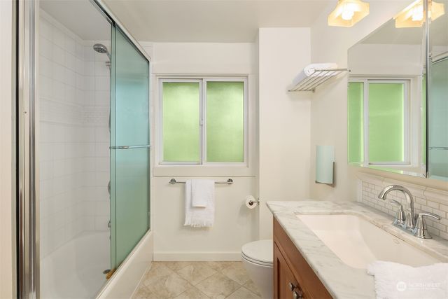 a front view of a house with a yard and flowers