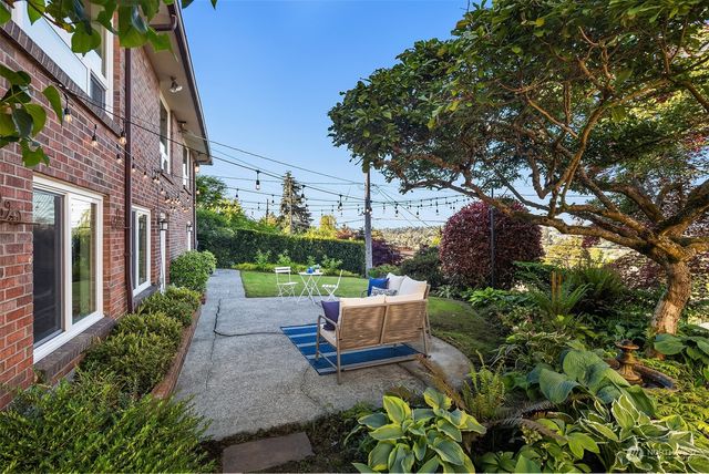 a view of a house with a yard porch and sitting area