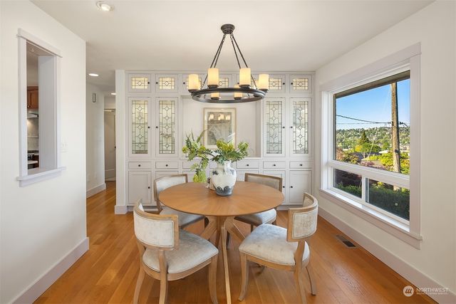 a dining room with furniture and wooden floor