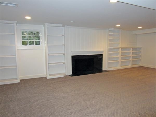 45 Old Farm Road Wellesley, MA 02481 - Photo 15 of 20 an empty room with furniture and a fireplace