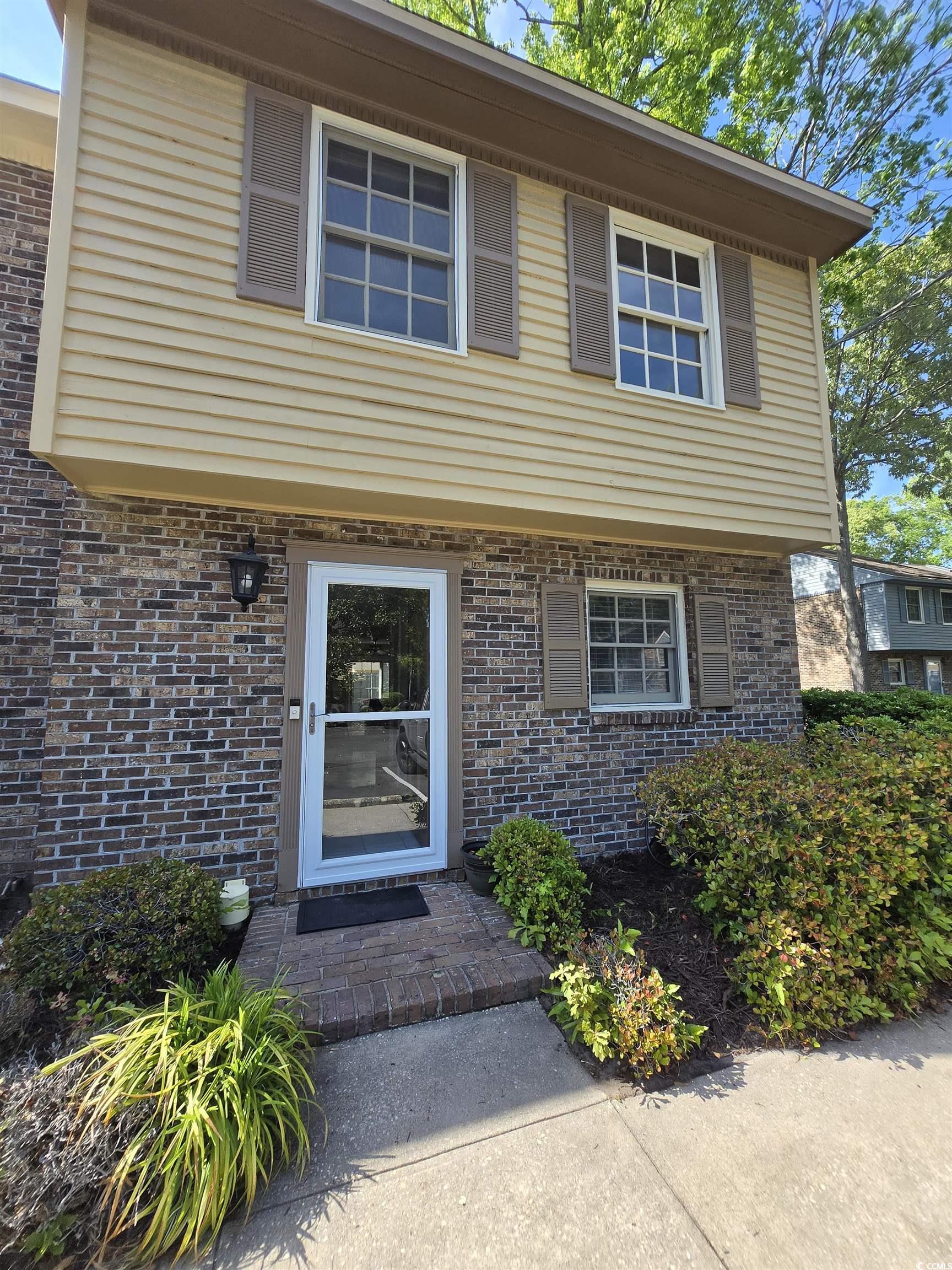 830 44th Avenue North, Unit B4 Myrtle Beach, SC 29577 - Photo 1 of 13 View of exterior entry with brick siding