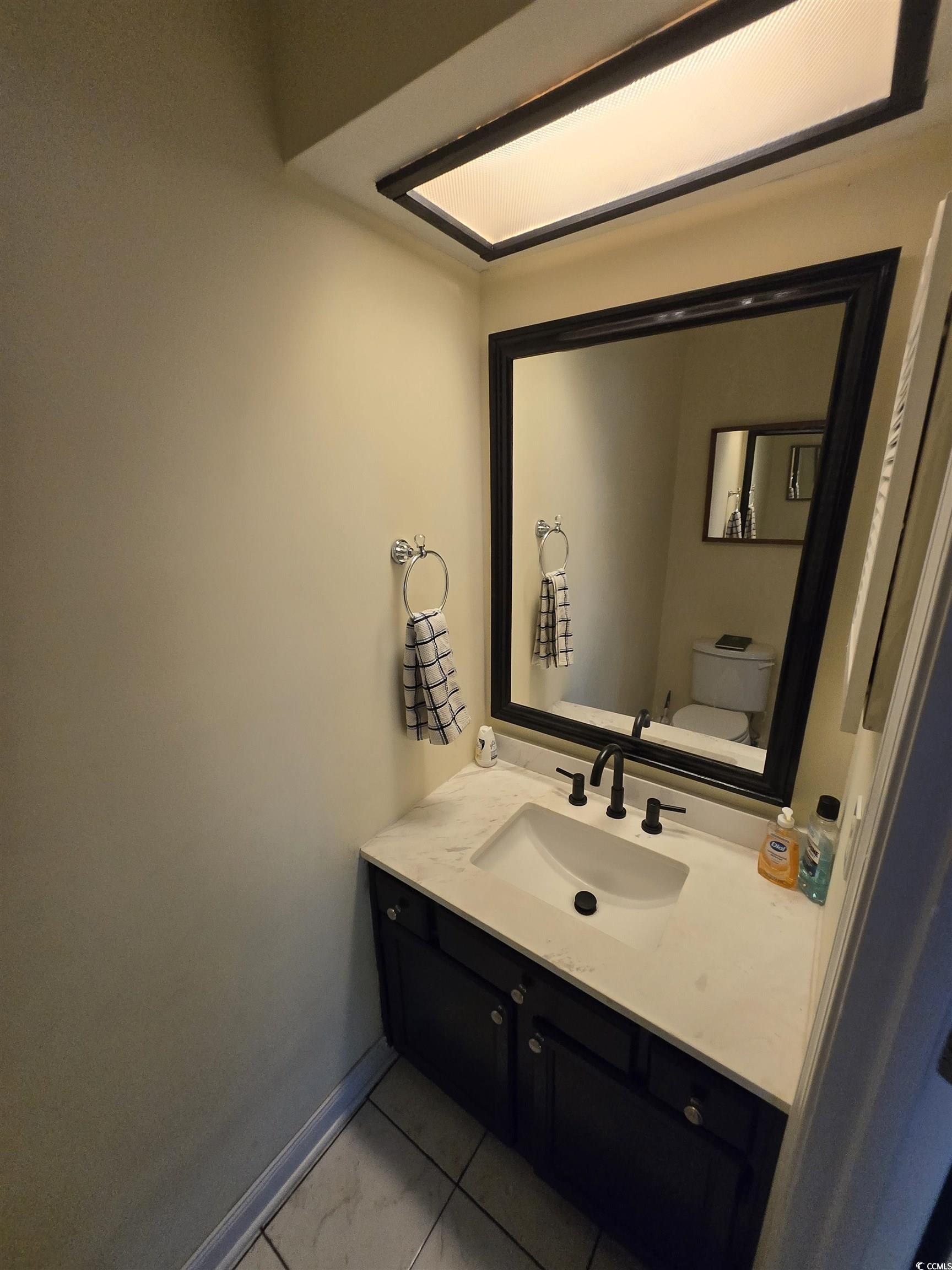 830 44th Avenue North, Unit B4 Myrtle Beach, SC 29577 - Photo 8 of 13 Bathroom with vanity and light tile patterned floors