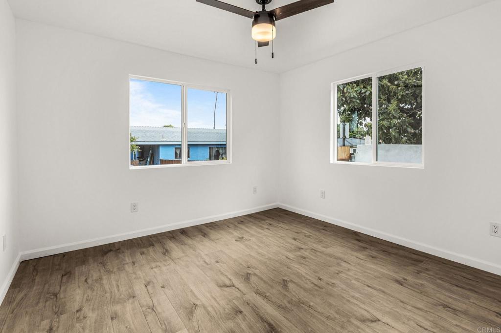 1038 Delaware Street Imperial Beach, CA 91932 - Photo 23 of 37 an empty room with wooden floor cabinet and windows