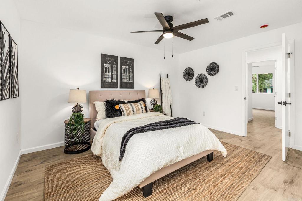 1038 Delaware Street Imperial Beach, CA 91932 - Photo 25 of 37 a bedroom with a bed a window and a potted plant