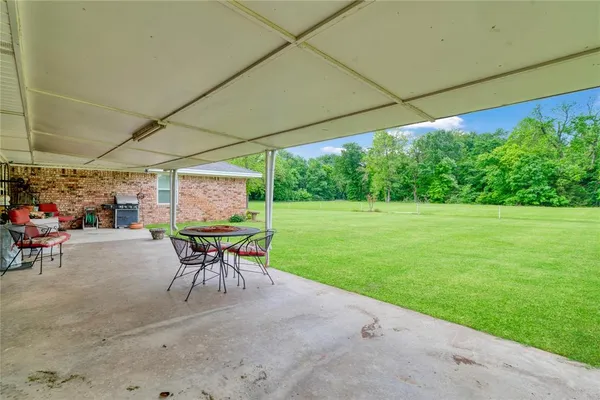 a patio with a patio table and chairs