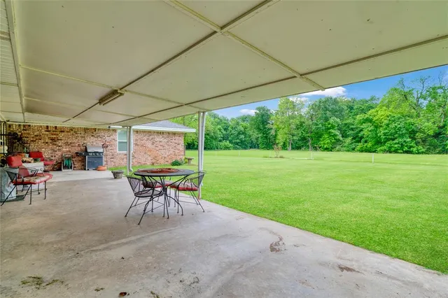 a patio with a patio table and chairs