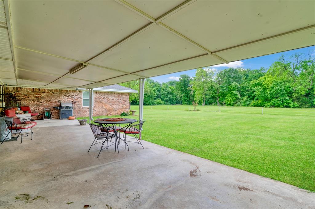 1355 County Road 33100 Sumner, TX 75486 - Photo 20 of 34 a patio with a patio table and chairs