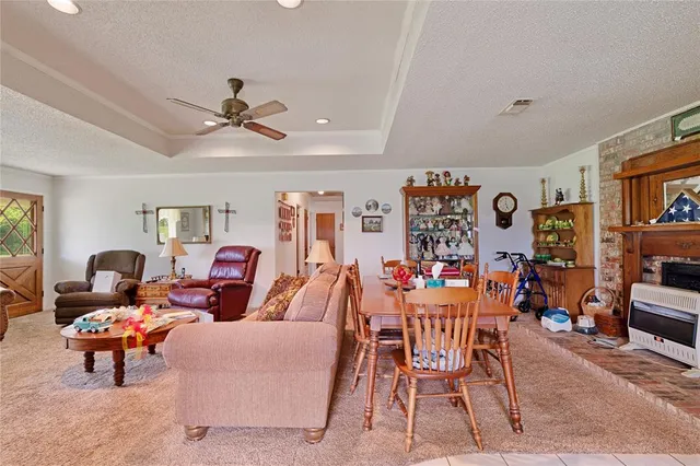 a living room with furniture kitchen view and a window