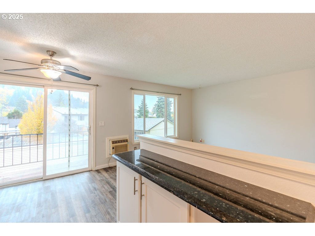 200 Southwest Florence Avenue, Unit D15 Gresham, OR 97080 - Photo 11 of 29 a kitchen view with wooden floor and a window