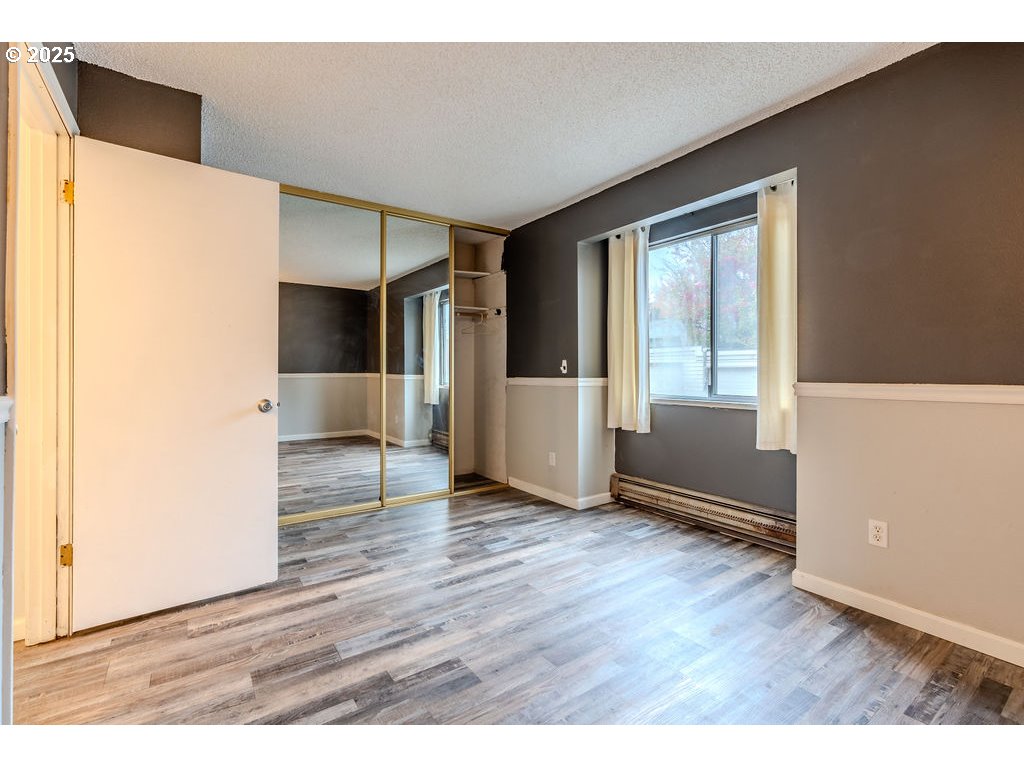 200 Southwest Florence Avenue, Unit D15 Gresham, OR 97080 - Photo 13 of 29 a view of an empty room with wooden floor and a window