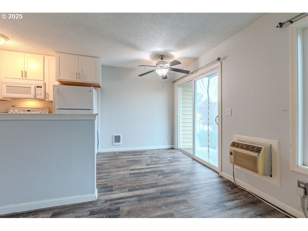 200 Southwest Florence Avenue, Unit D15 Gresham, OR 97080 - Photo 6 of 29 a view of a kitchen with wooden floor and a ceiling fan