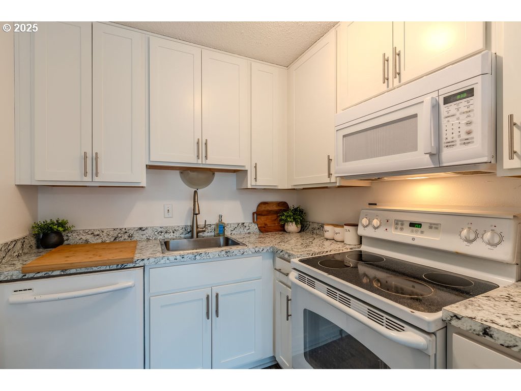 200 Southwest Florence Avenue, Unit D15 Gresham, OR 97080 - Photo 10 of 29 a kitchen with stainless steel appliances granite countertop a sink stove and cabinets