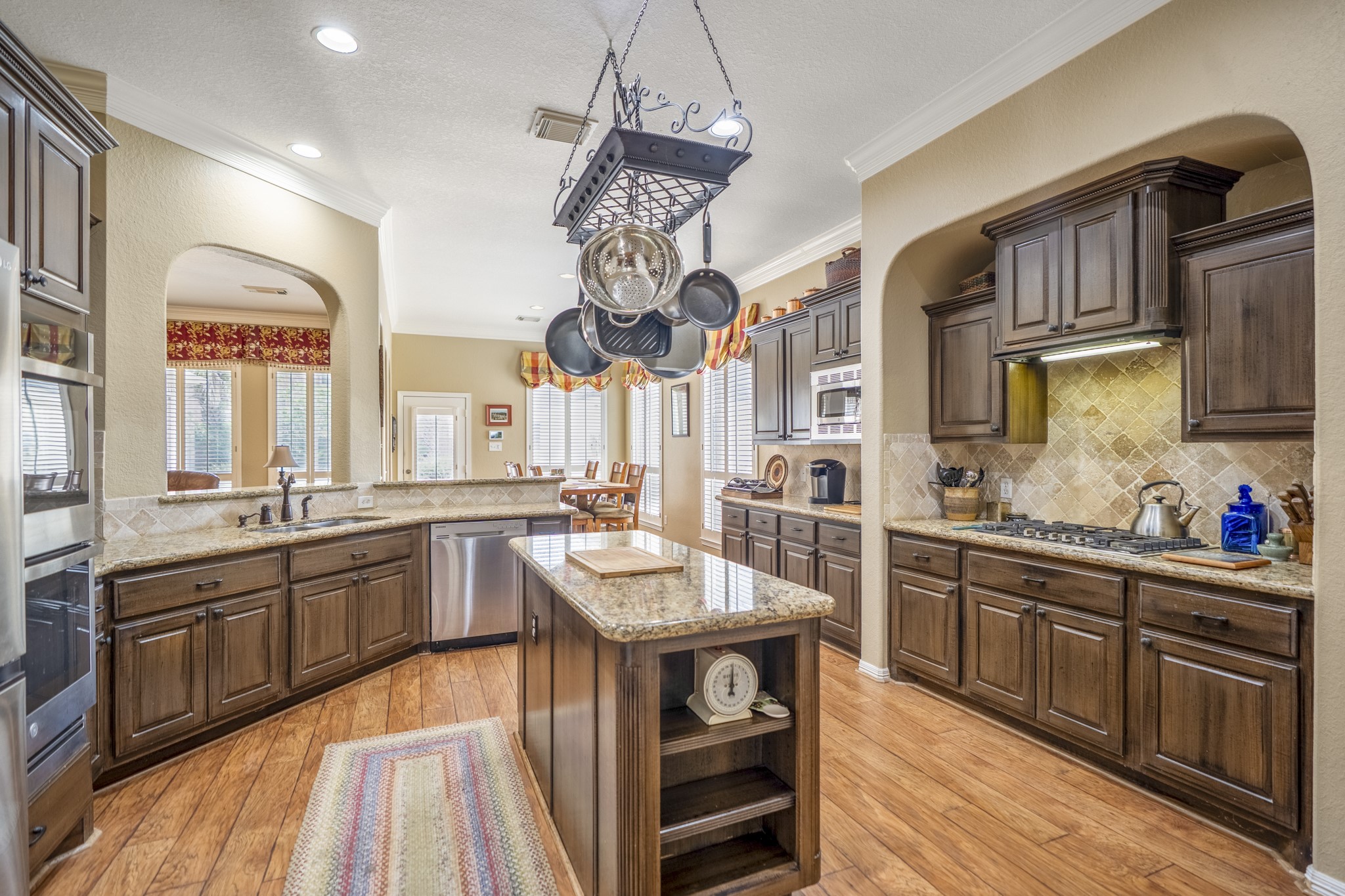 1438 Hatchmere Place Spring, TX 77379 - Photo 12 of 50 The island kitchen has everything the modern Chef may need, with double ovens, a five-burner gas range, gorgeous wood cabinetry and spacious breakfast area.