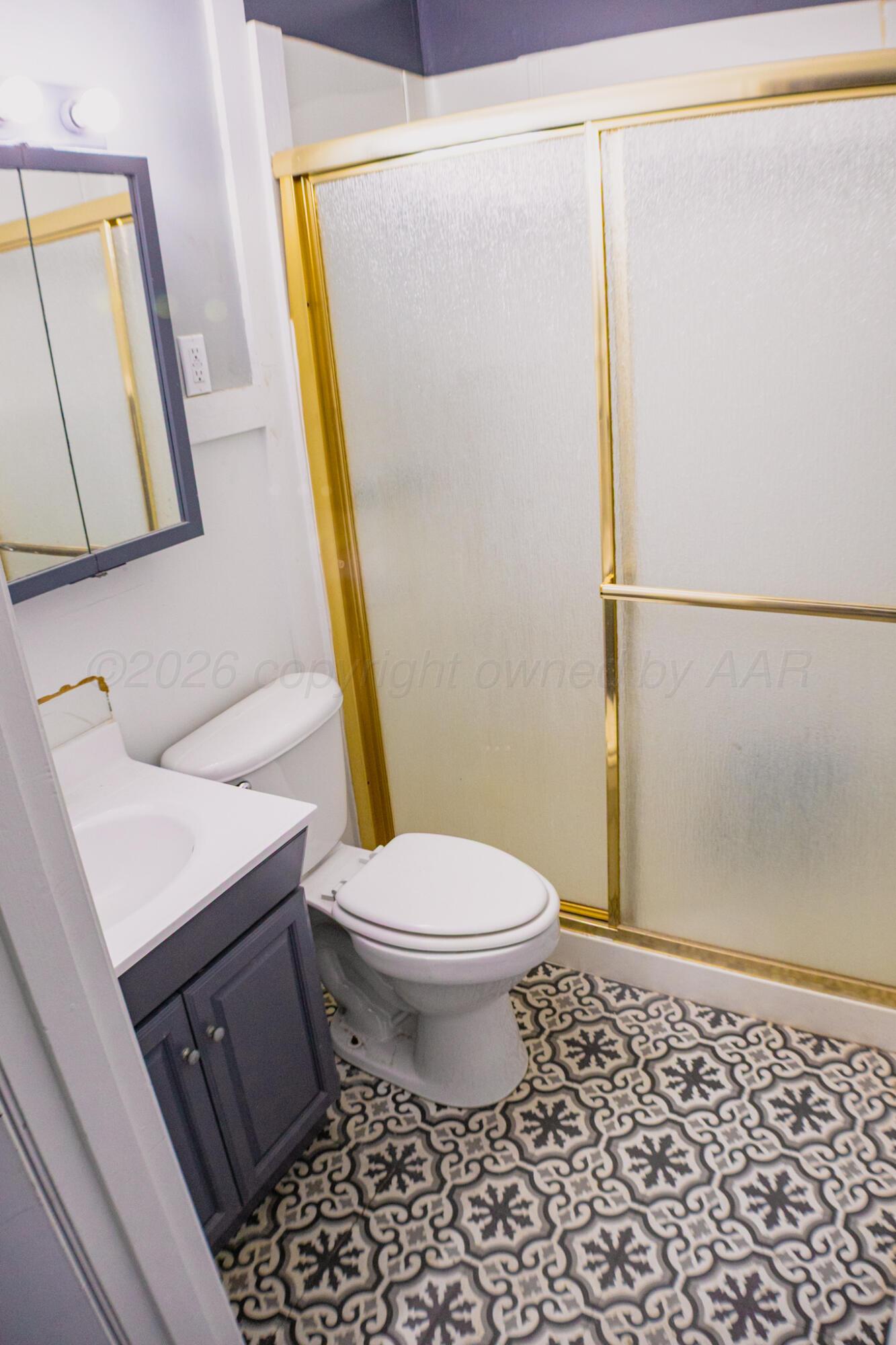 211 Butadieno Street Borger, TX 79007 - Photo 12 of 26 a bathroom with a sink a toilet a mirror and shower