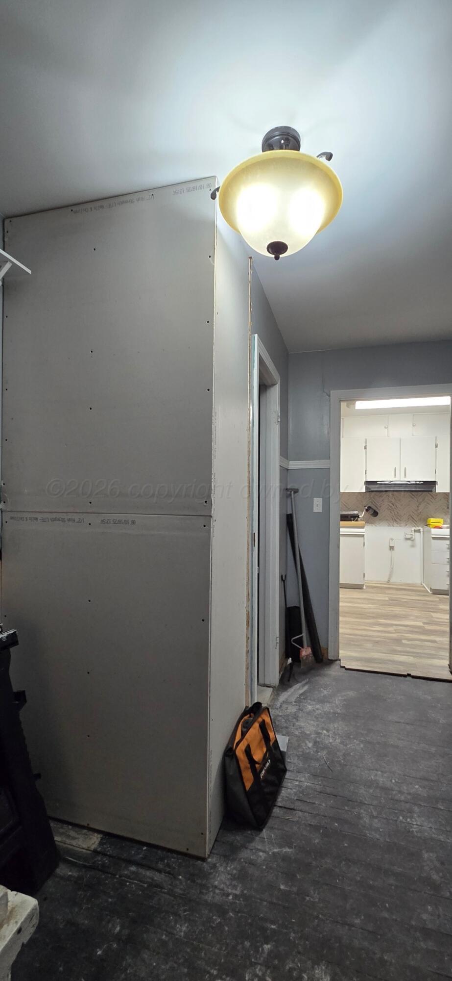 211 Butadieno Street Borger, TX 79007 - Photo 16 of 26 a view of a room with wooden floor and windows