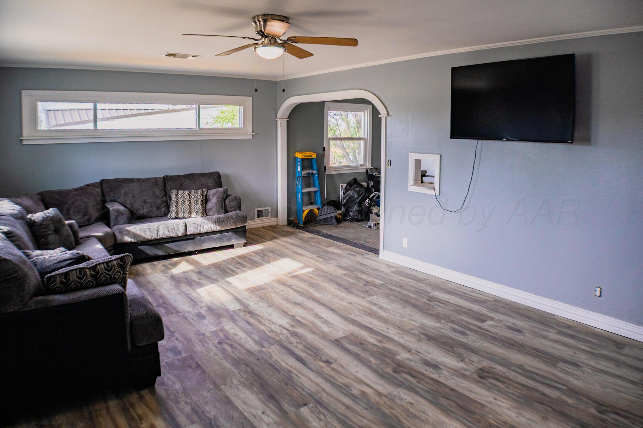 211 Butadieno Street Borger, TX 79007 - Photo 5 of 26 a living room with furniture and a flat screen tv