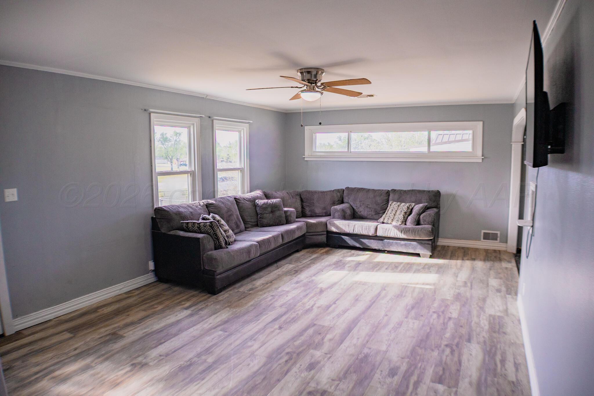 211 Butadieno Street Borger, TX 79007 - Photo 6 of 26 a living room with furniture and a flat screen tv