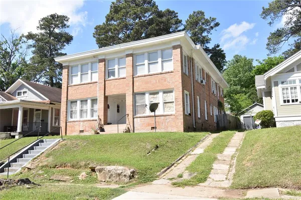 a view of a brick building next to a yard