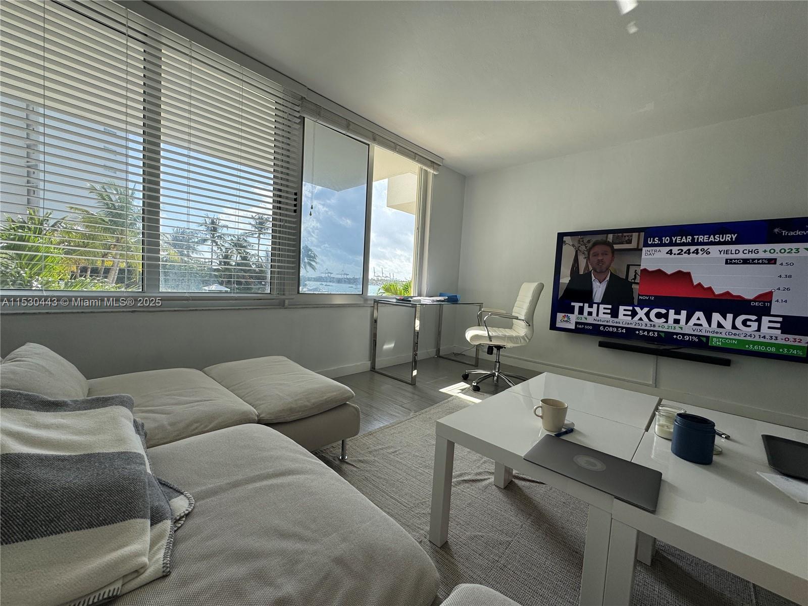 1200 West Avenue, Unit 202 Miami Beach, FL 33139 - Photo 14 of 45 a living room with furniture and a flat screen tv