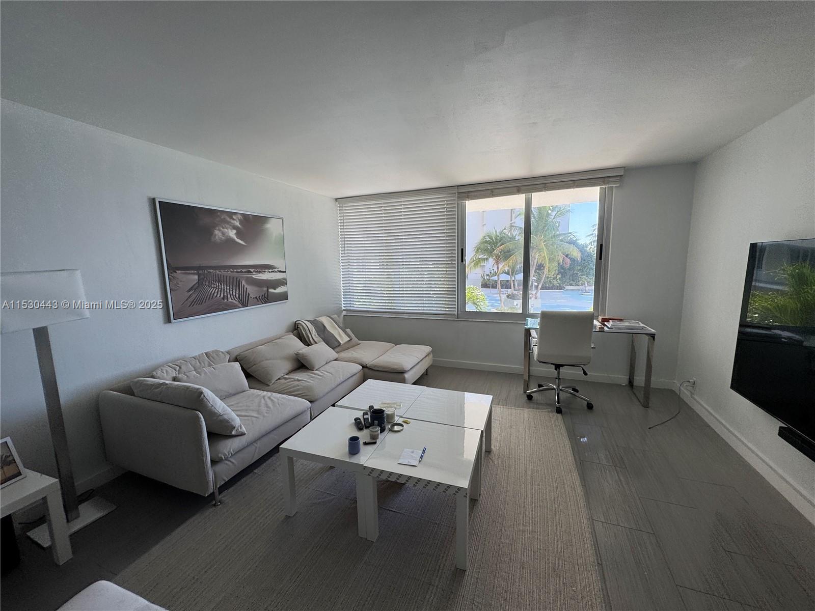 1200 West Avenue, Unit 202 Miami Beach, FL 33139 - Photo 15 of 45 a living room with furniture and a flat screen tv