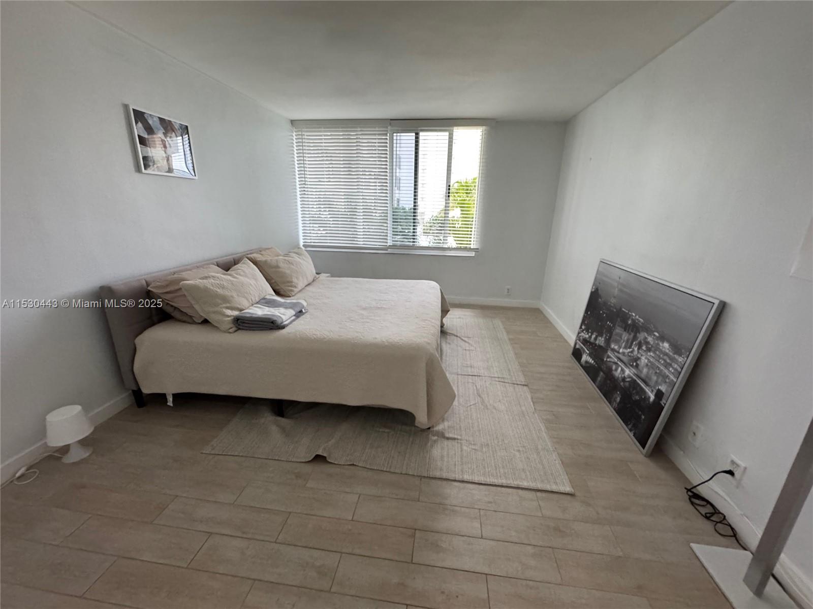1200 West Avenue, Unit 202 Miami Beach, FL 33139 - Photo 22 of 45 a bedroom with a bed and a couch