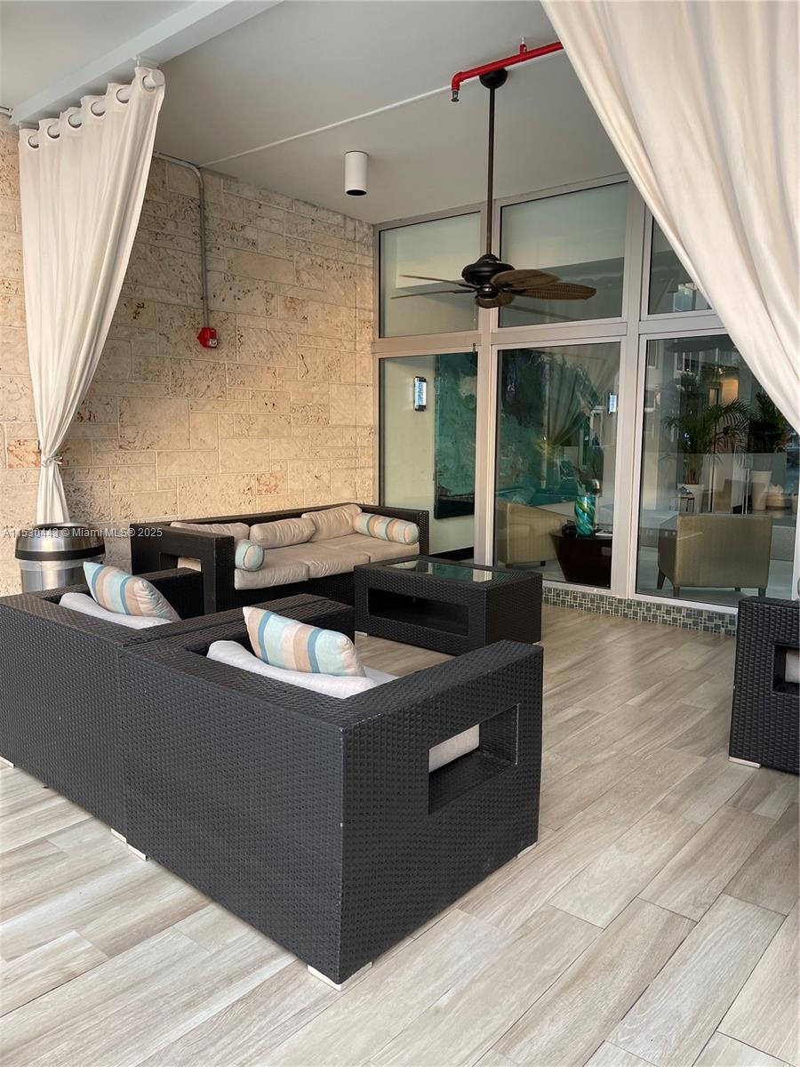 1200 West Avenue, Unit 202 Miami Beach, FL 33139 - Photo 23 of 45 a kitchen with stainless steel appliances granite countertop a sink a stove and a wooden floor