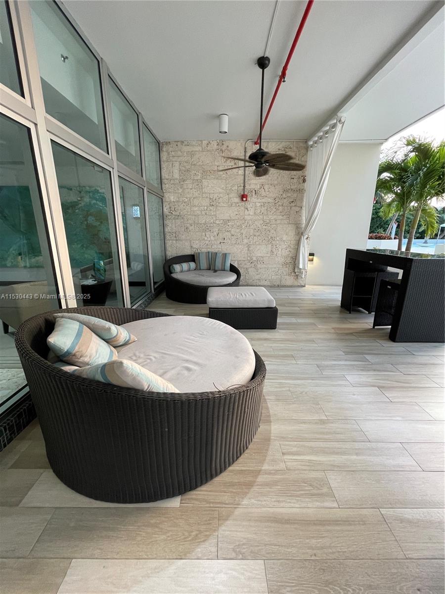 1200 West Avenue, Unit 202 Miami Beach, FL 33139 - Photo 25 of 45 a living room with a couch and a floor to ceiling window