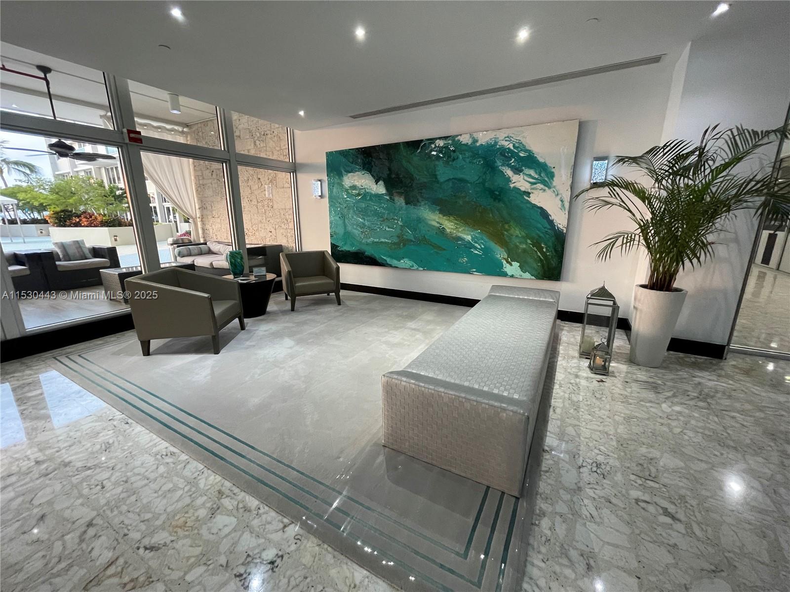 1200 West Avenue, Unit 202 Miami Beach, FL 33139 - Photo 26 of 45 a living room with furniture tv and floor to ceiling window