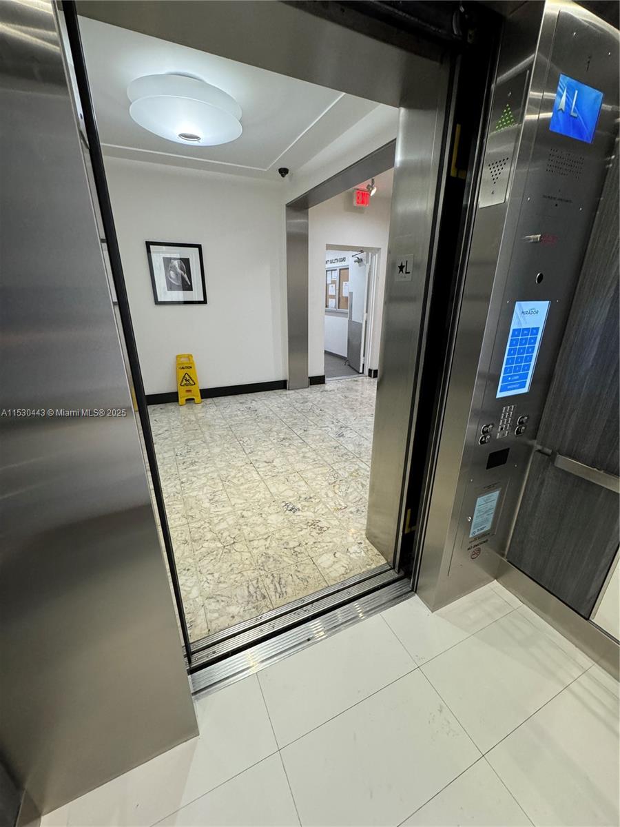 1200 West Avenue, Unit 202 Miami Beach, FL 33139 - Photo 28 of 45 a view of a hallway with wooden floor and staircase